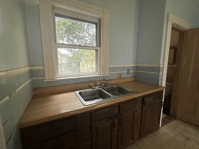 a bathroom with a sink and a window