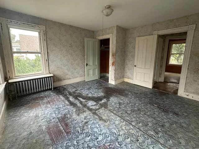 wooden floor and window in an empty room