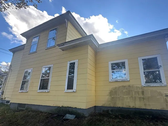 a view of a brick house with many windows