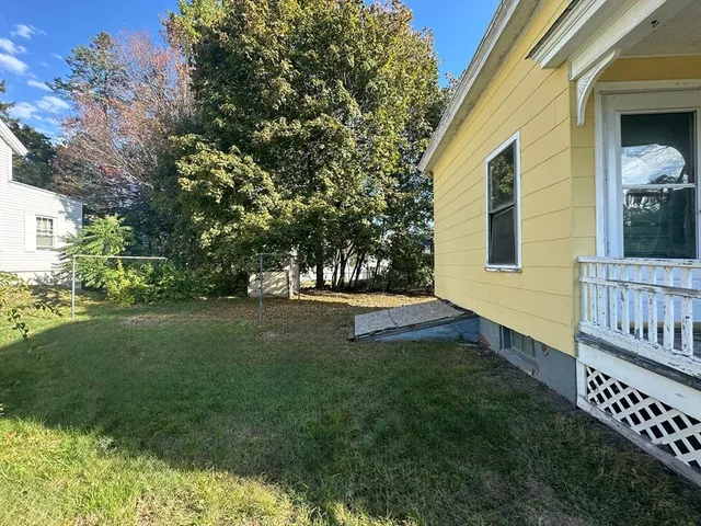 a view of house with backyard and garden