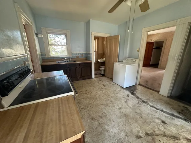 a kitchen with a refrigerator and a sink