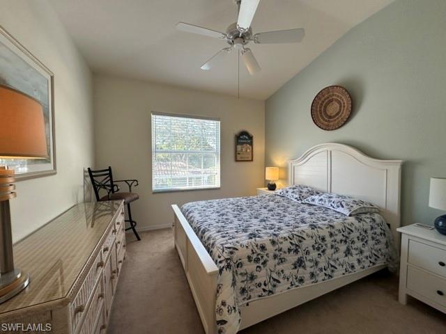 6800 Satinleaf Road South, Unit 202 Naples, FL 34109 - Photo 12 of 15 a bedroom with a bed and a chandelier