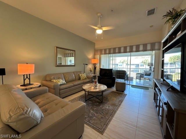 6800 Satinleaf Road South, Unit 202 Naples, FL 34109 - Photo 3 of 15 a living room with furniture and a flat screen tv