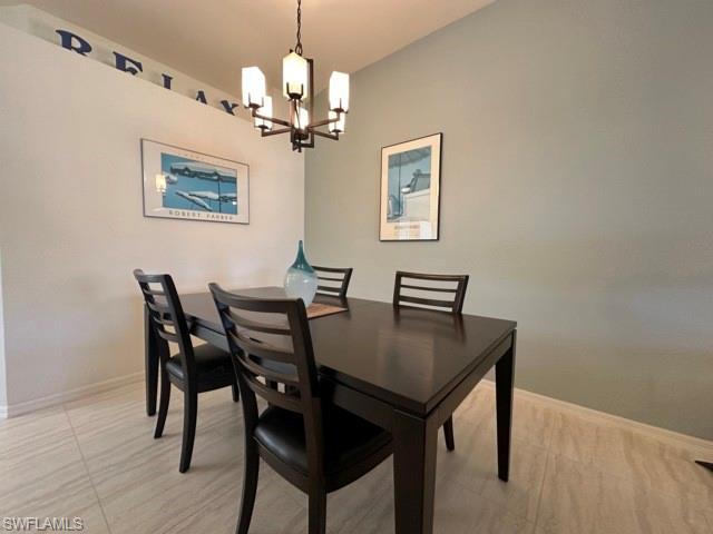 6800 Satinleaf Road South, Unit 202 Naples, FL 34109 - Photo 6 of 15 a view of a dining room with furniture and wooden floor