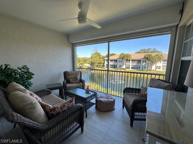 6800 Satinleaf Road South, Unit 202 Naples, FL 34109 - Photo 8 of 15 a living room with furniture and a floor to ceiling window