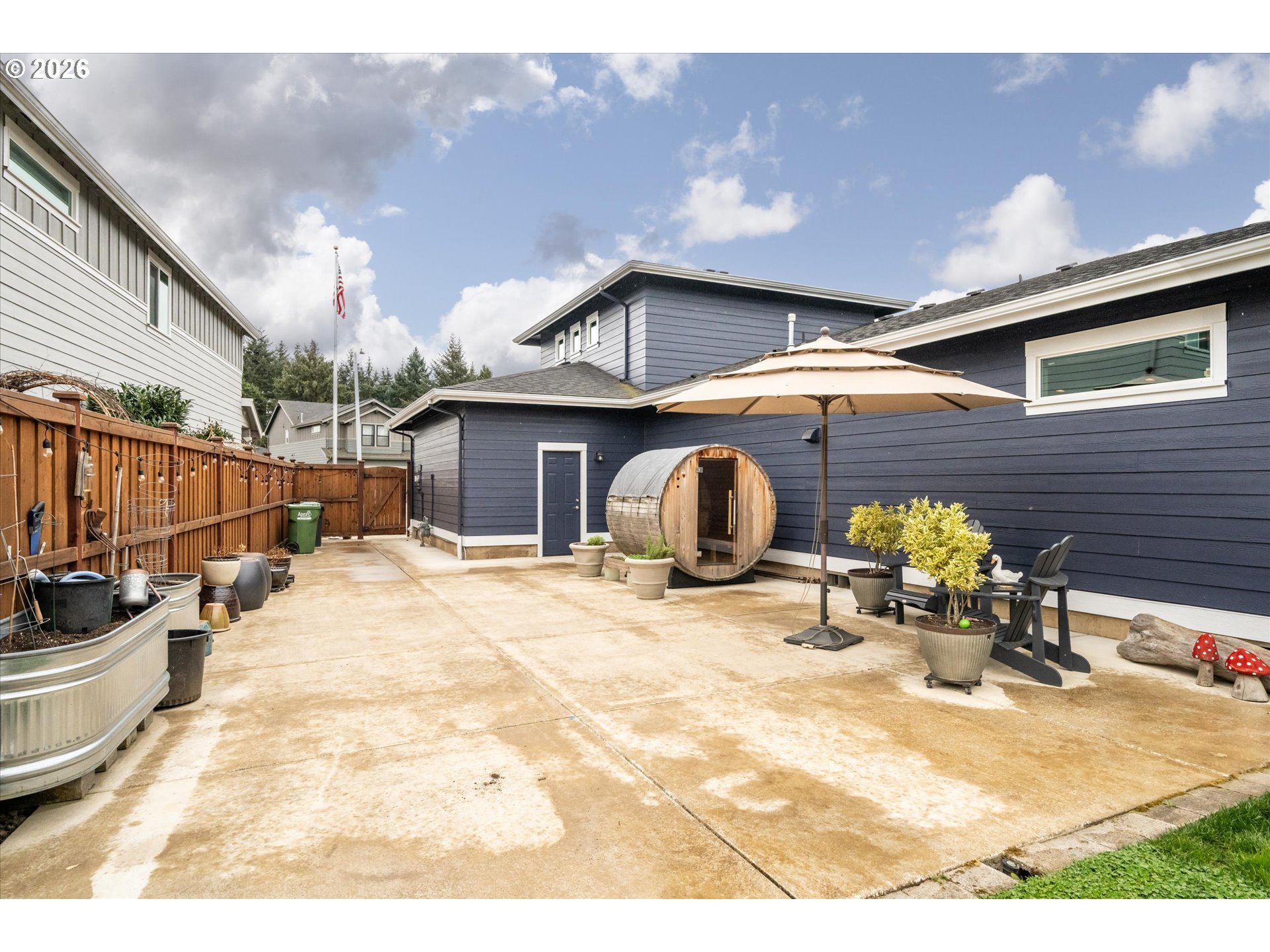 709 Tyson Lane Eugene, OR 97404 - Photo 21 of 31 a view of a patio with a table and chairs under an umbrella