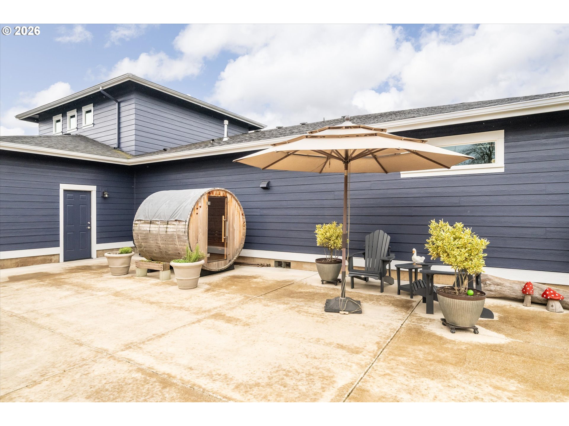 709 Tyson Lane Eugene, OR 97404 - Photo 22 of 31 a white house with a large outdoor space and seating area