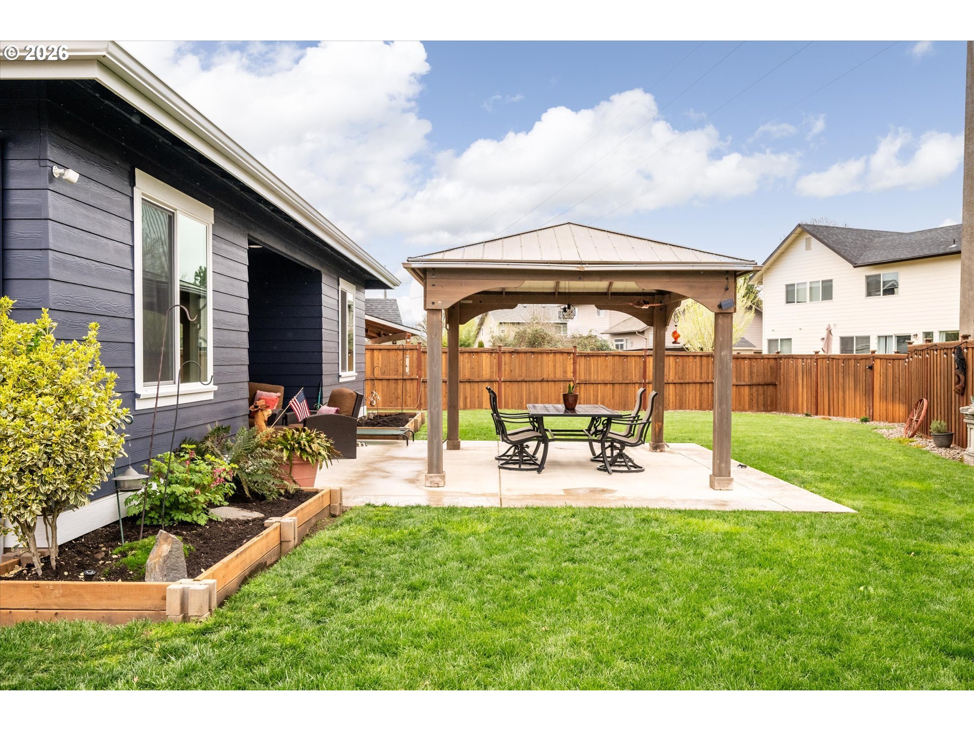 709 Tyson Lane Eugene, OR 97404 - Photo 23 of 31 a view of a house with backyard sitting area and garden