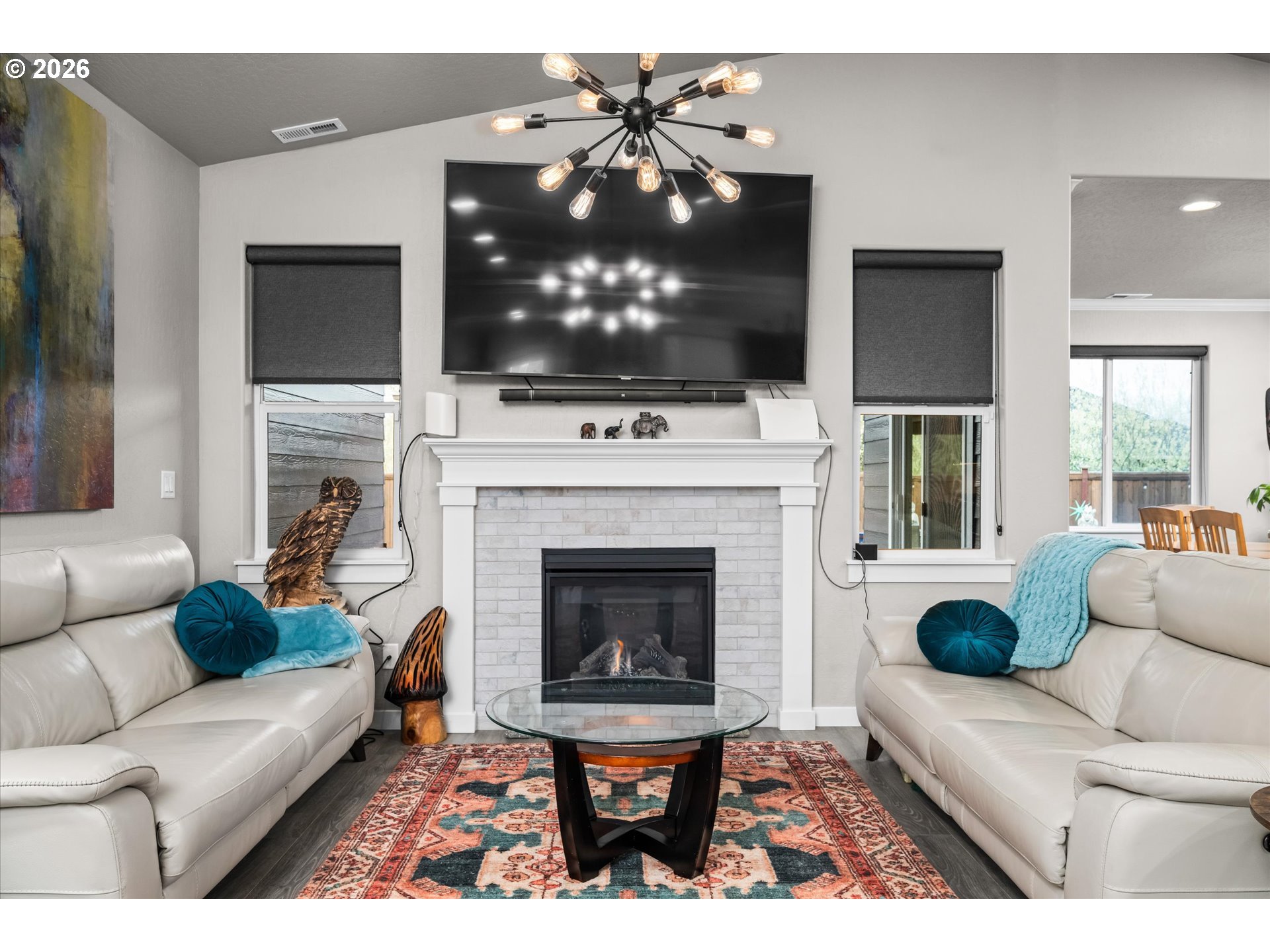 709 Tyson Lane Eugene, OR 97404 - Photo 3 of 31 a living room with furniture a flat screen tv and a fireplace