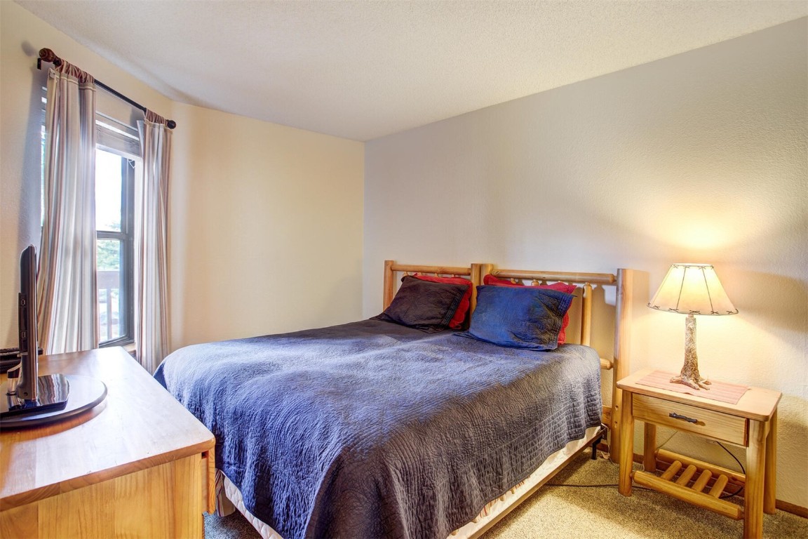 570 Bills Ranch Road, Unit 115 Frisco, CO 80443 - Photo 15 of 31 a large bed sitting in a bedroom next to a window