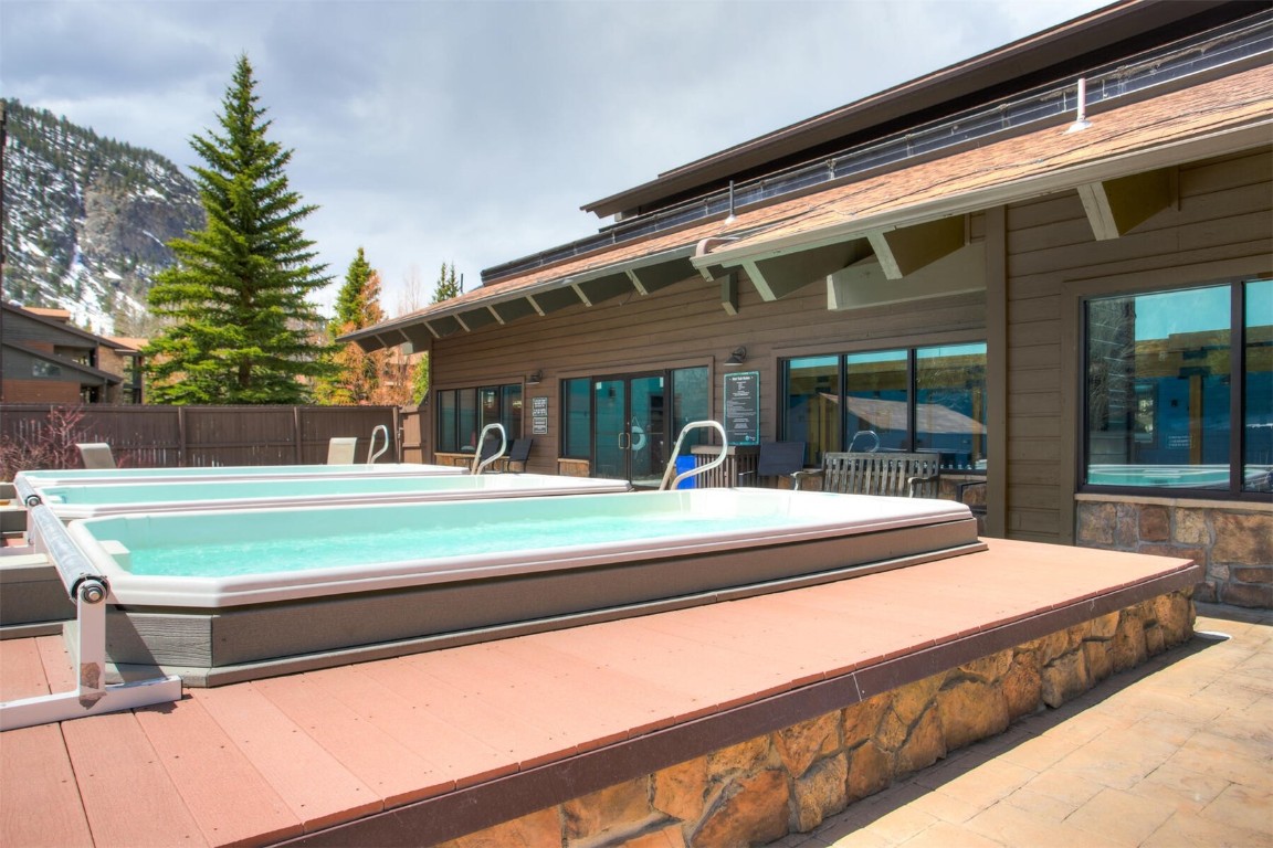 570 Bills Ranch Road, Unit 115 Frisco, CO 80443 - Photo 22 of 31 a view of a house with a backyard patio and swimming pool
