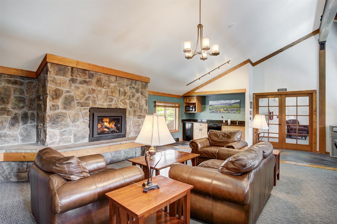 570 Bills Ranch Road, Unit 115 Frisco, CO 80443 - Photo 28 of 31 a living room with furniture a fireplace and a chandelier