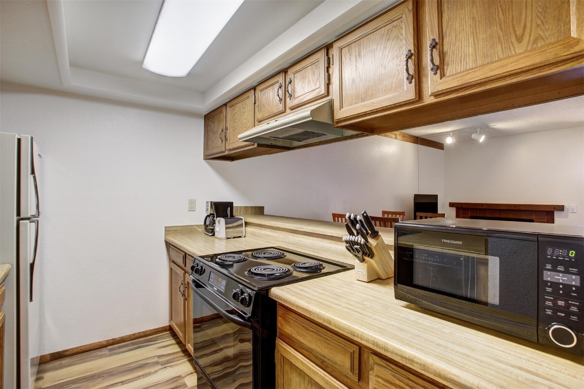 570 Bills Ranch Road, Unit 115 Frisco, CO 80443 - Photo 10 of 31 a kitchen with stainless steel appliances granite countertop a stove and a microwave