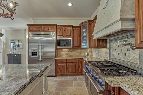 a kitchen with stainless steel appliances wooden floor dining table and chairs