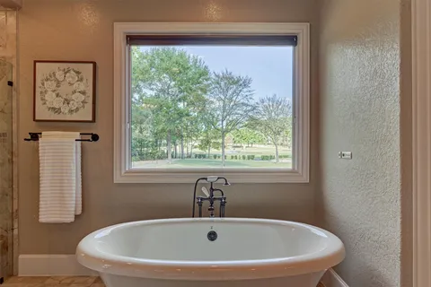 a spacious bathroom with a granite countertop sink toilet and shower