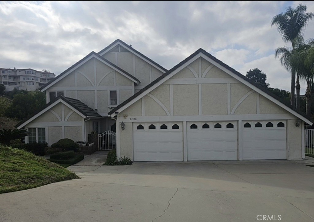 a view of a house with a yard and garage