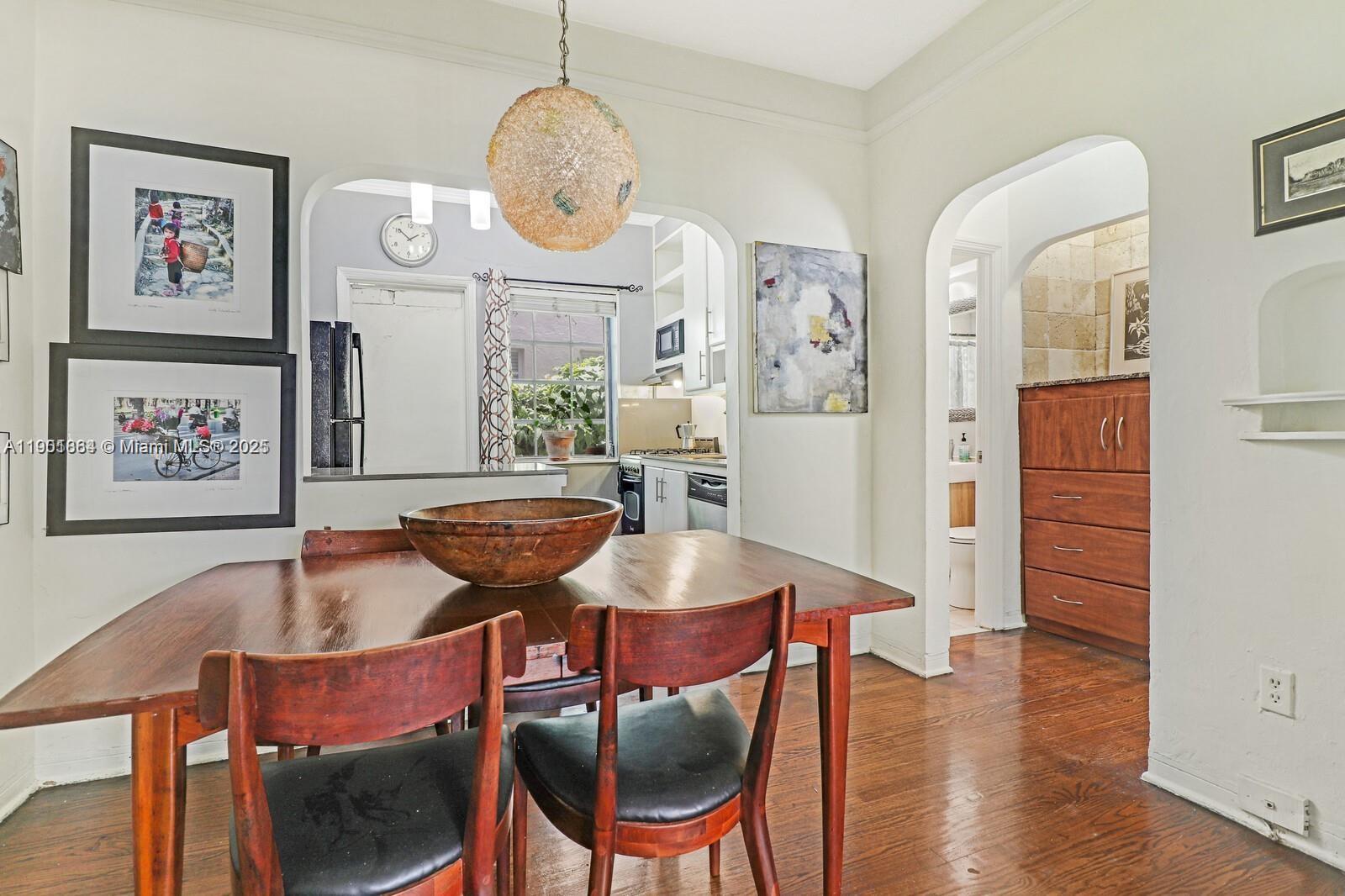 1250 Drexel Avenue, Unit 7 Miami Beach, FL 33139 - Photo 11 of 30 a living room with furniture kitchen view and a chandelier