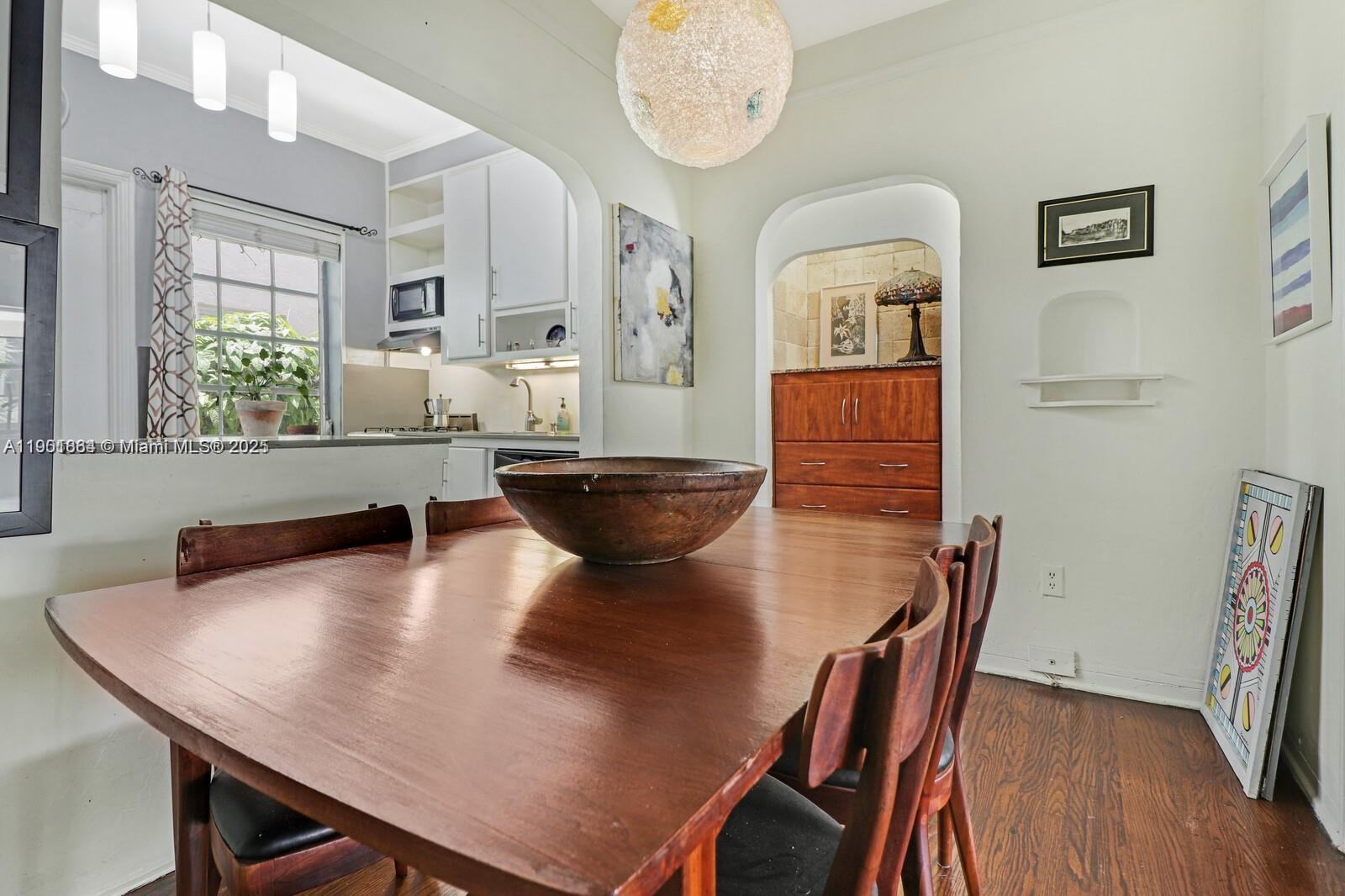 1250 Drexel Avenue, Unit 7 Miami Beach, FL 33139 - Photo 12 of 30 a living room with dining table and wooden floor