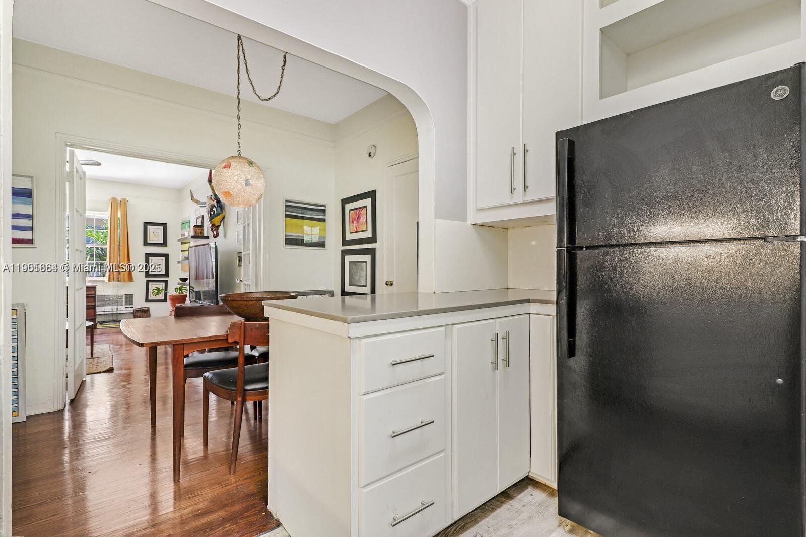 1250 Drexel Avenue, Unit 7 Miami Beach, FL 33139 - Photo 16 of 30 a kitchen with cabinets and stainless steel appliances