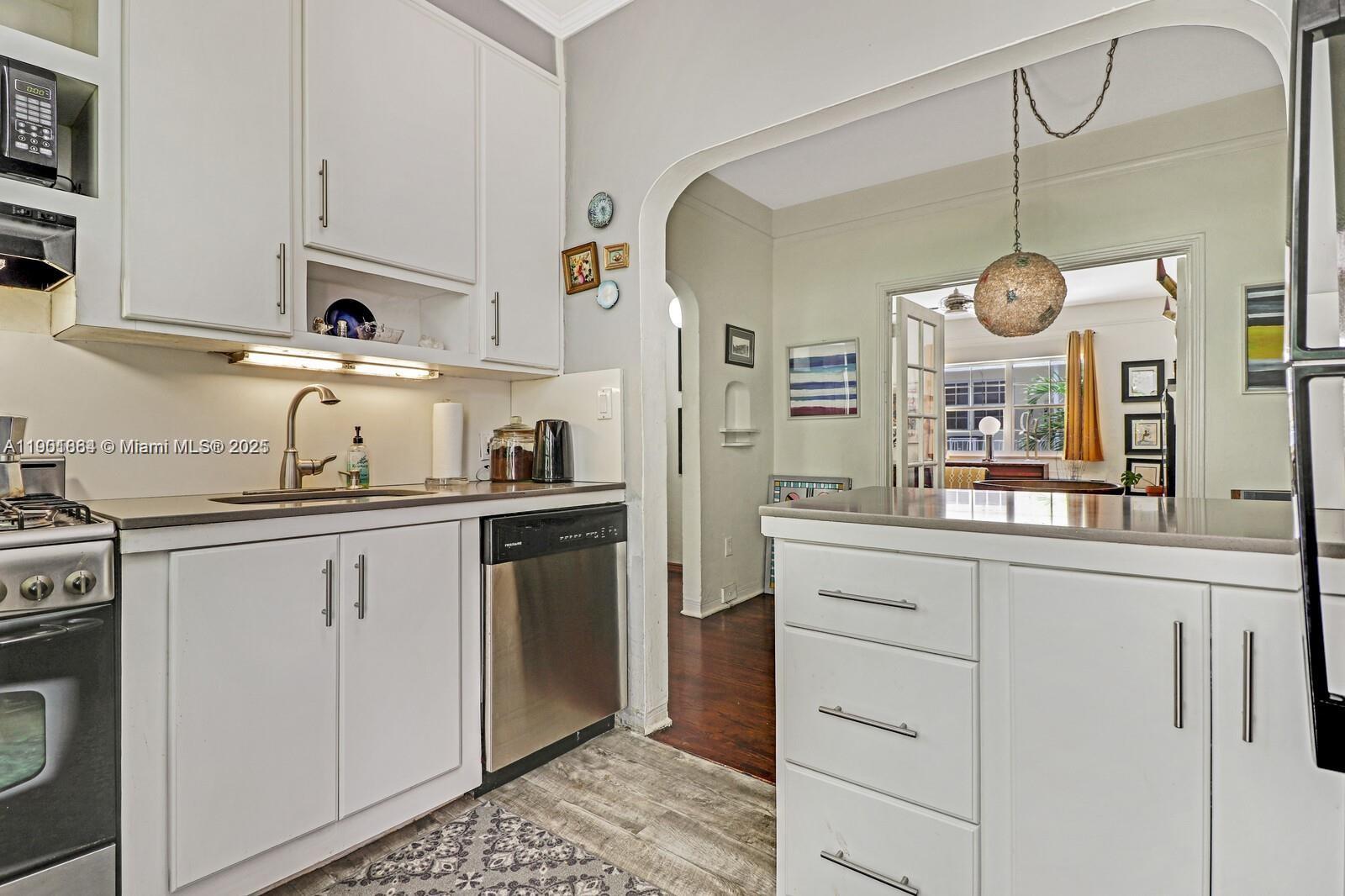 1250 Drexel Avenue, Unit 7 Miami Beach, FL 33139 - Photo 17 of 30 a kitchen with cabinets and stainless steel appliances