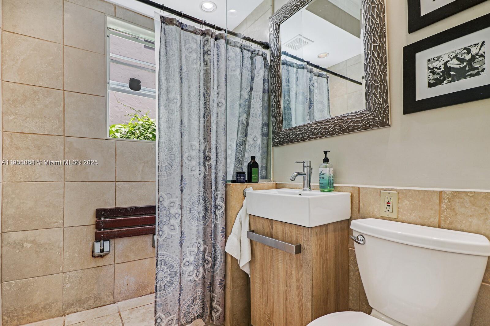 1250 Drexel Avenue, Unit 7 Miami Beach, FL 33139 - Photo 20 of 30 a bathroom with a sink toilet and shower