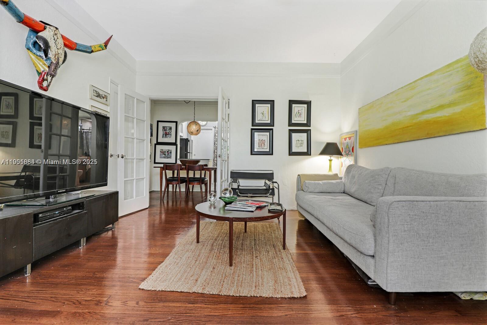 1250 Drexel Avenue, Unit 7 Miami Beach, FL 33139 - Photo 2 of 30 a living room with furniture and a flat screen tv