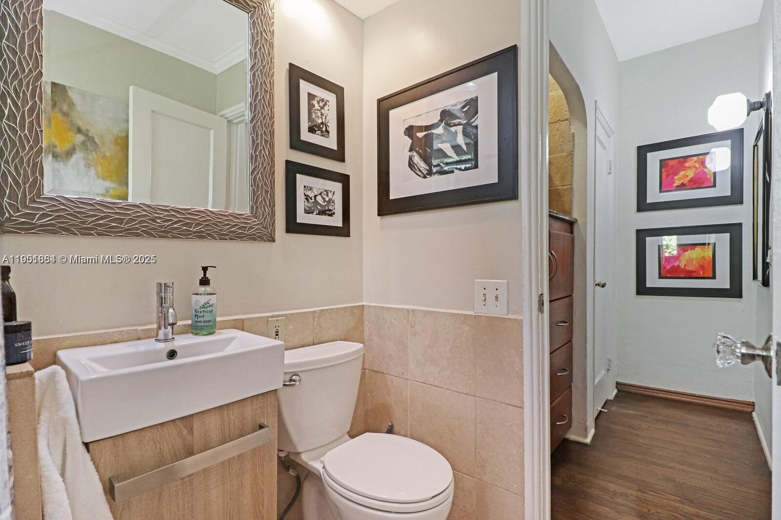 1250 Drexel Avenue, Unit 7 Miami Beach, FL 33139 - Photo 21 of 30 a bathroom with a toilet a sink and a mirror