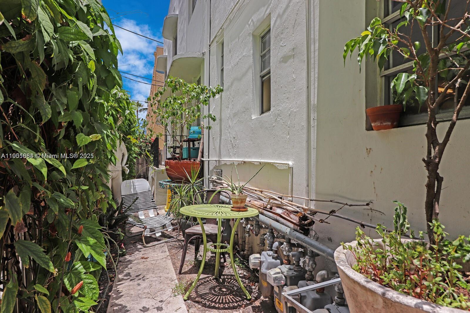 1250 Drexel Avenue, Unit 7 Miami Beach, FL 33139 - Photo 23 of 30 a backyard of a house with table and chairs