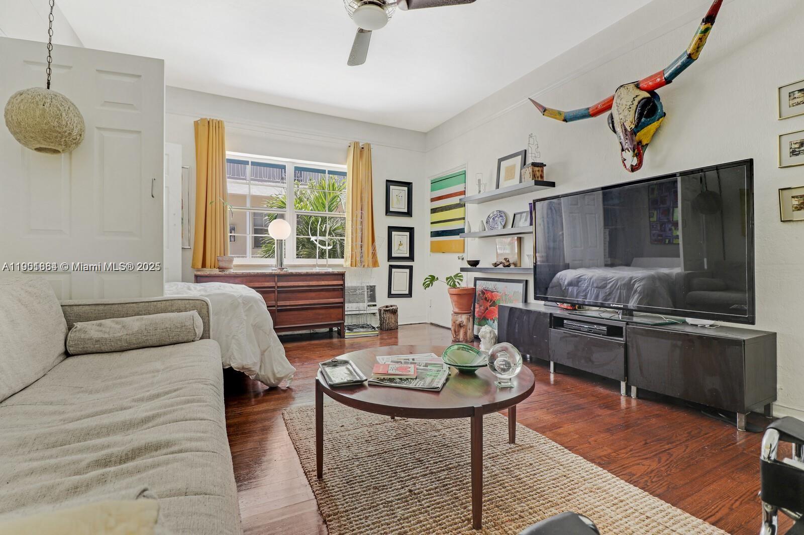 1250 Drexel Avenue, Unit 7 Miami Beach, FL 33139 - Photo 7 of 30 a living room with furniture a flat screen tv and a table