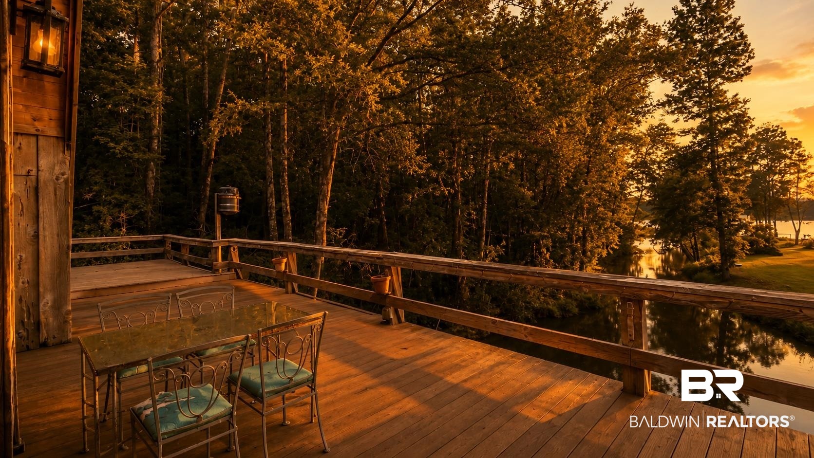 14587 Ridge Road Summerdale, AL 36580 - Photo 41 of 44 Expansive wood deck with plank flooring and a rustic wood railing, featuring a visible water feature bordered by mature trees