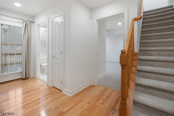 a view of hallway with wooden floor