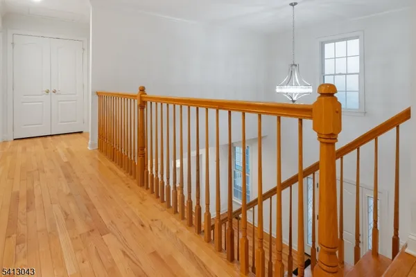 a view of a room with wooden floor and windows