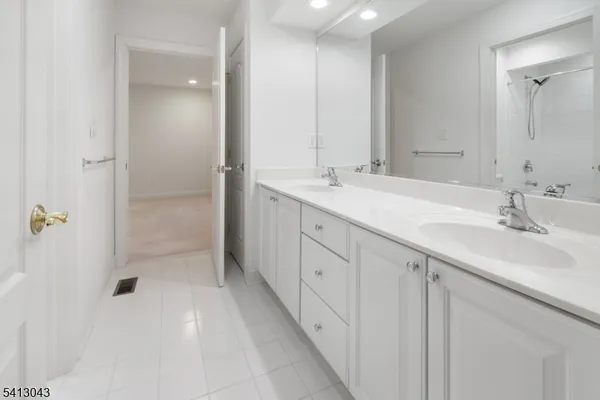 a bathroom with a double vanity sink and mirror