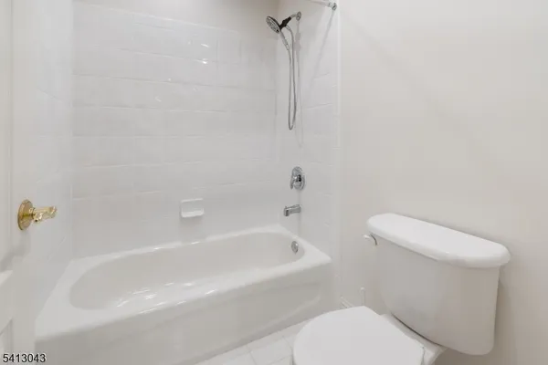 a white toilet sitting next to a bath tub