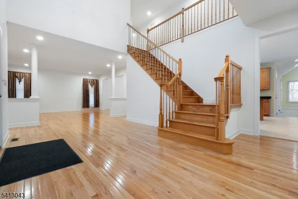 a view of entryway and hall with wooden floor