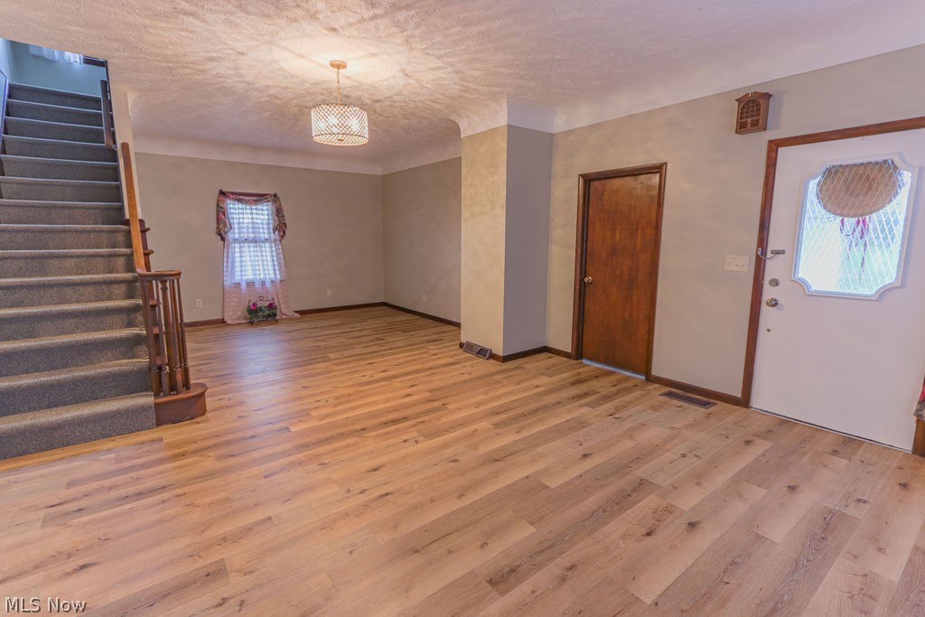 51883 Telegraph Road Amherst, OH 44001 - Photo 20 of 49 Foyer entrance featuring a textured ceiling and light wood-type flooring