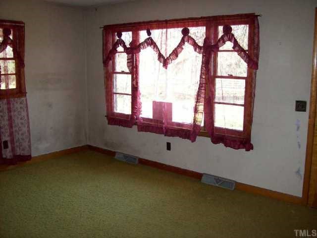 525 Pulliam-Tingen Mine Road Roxboro, NC 27574 - Photo 3 of 9 an empty room with a window