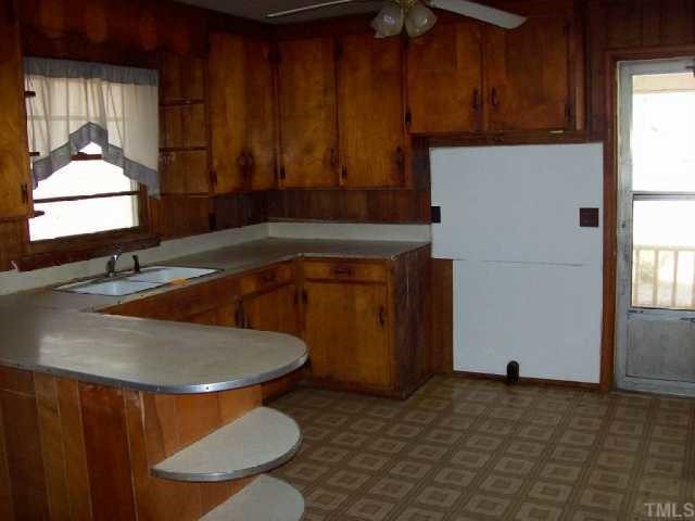 525 Pulliam-Tingen Mine Road Roxboro, NC 27574 - Photo 4 of 9 a kitchen with a sink and a stove