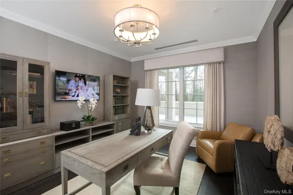 a view of a dining room with furniture a chandelier and wooden floor