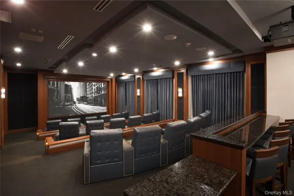 a media room with lots of chairs and a projector screen