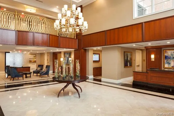 a view of a dining room with furniture chandelier and a chandelier
