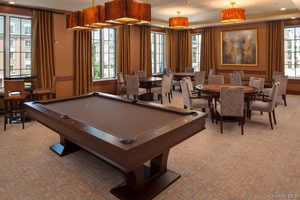 a room with pool table and windows