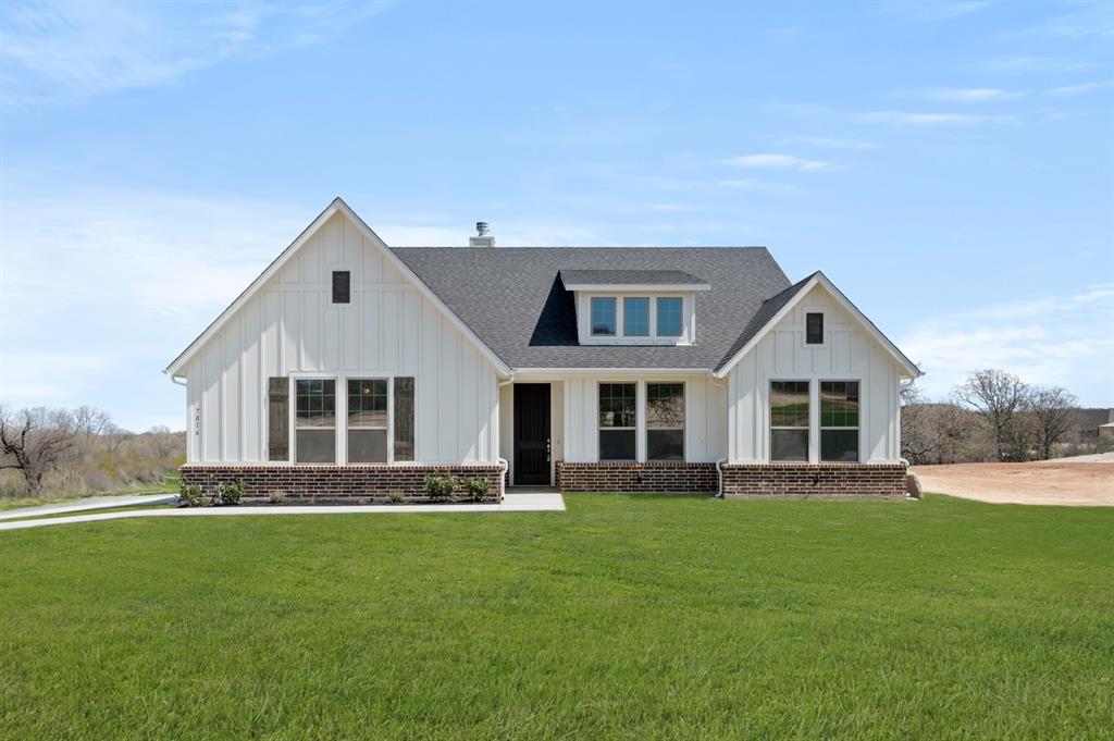 a front view of house with yard and green space