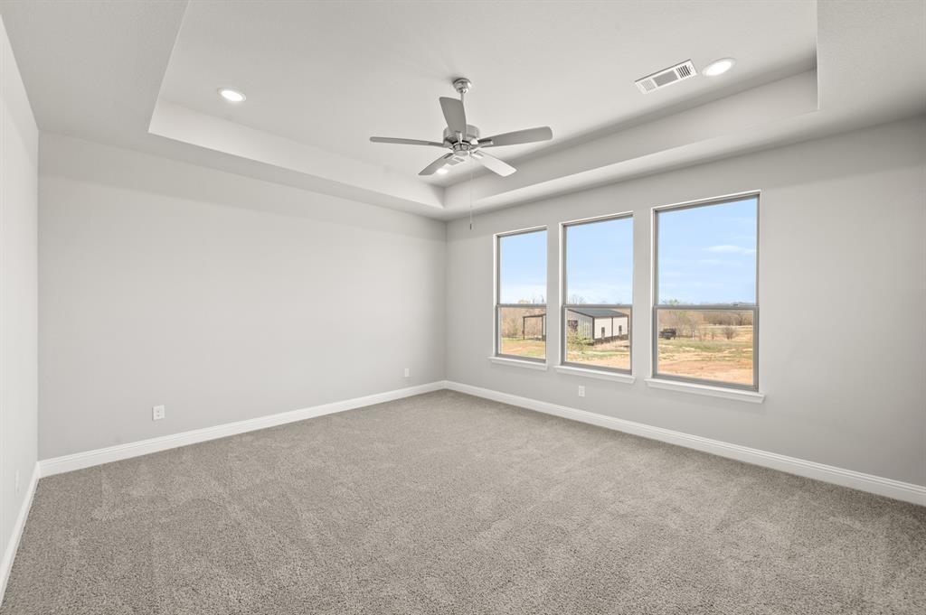 7016 Ranch View Place Springtown, TX 76082 - Photo 13 of 29 an empty room with a window and a ceiling fan