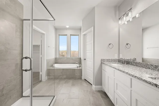 a bathroom with a granite countertop sink a toilet and bathtub