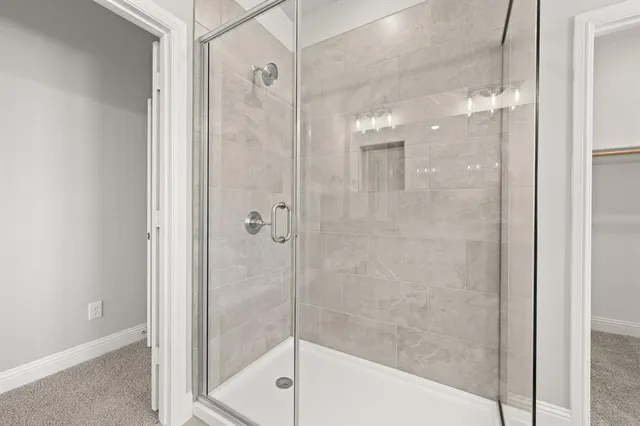 a bathroom with a shower and a bath tub