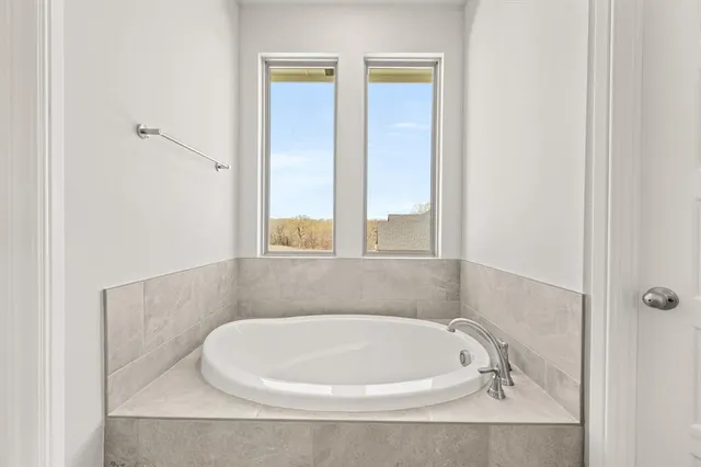 a white bath tub sitting in a bathroom