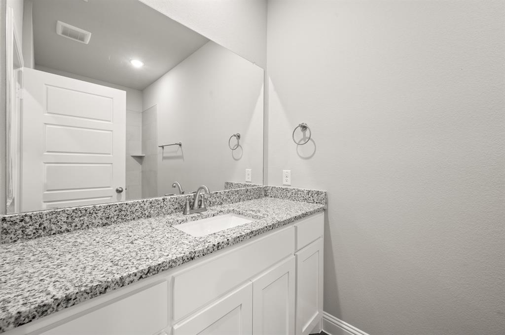 7016 Ranch View Place Springtown, TX 76082 - Photo 24 of 29 a bathroom with a granite countertop sink and a mirror
