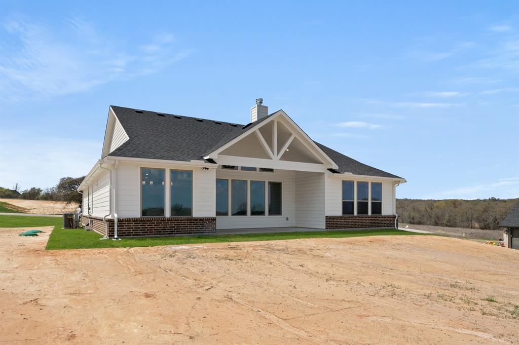 7016 Ranch View Place Springtown, TX 76082 - Photo 27 of 29 a front view of a house with a yard