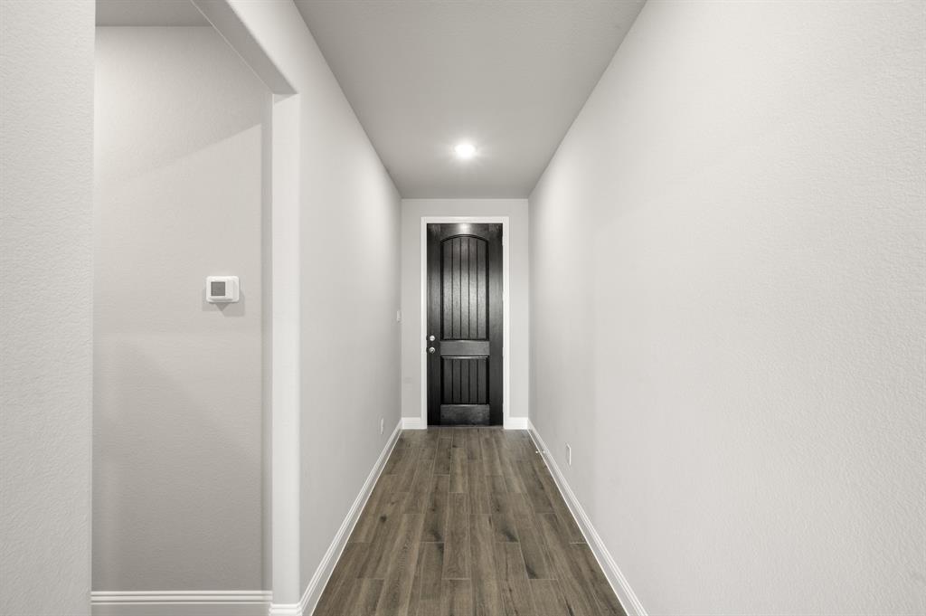 7016 Ranch View Place Springtown, TX 76082 - Photo 3 of 29 a view of a hallway with wooden floor